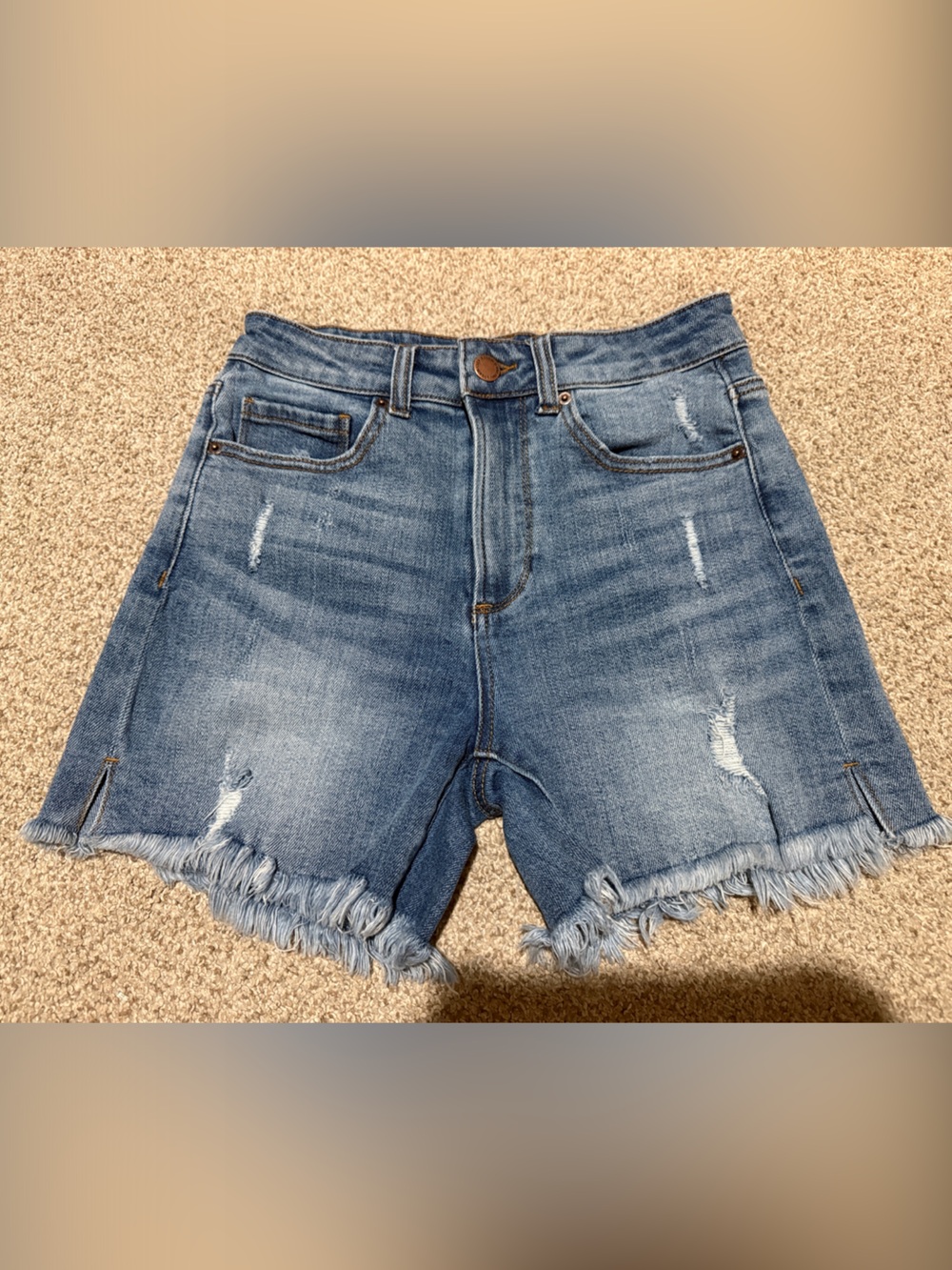 High-Rise Distressed Denim Shorts in Medium Blue